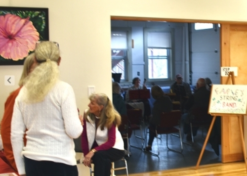 Artists mingle while listening to music.
