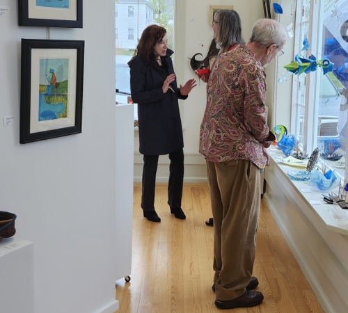 Artists' reception visitors enjoy art and conversation.